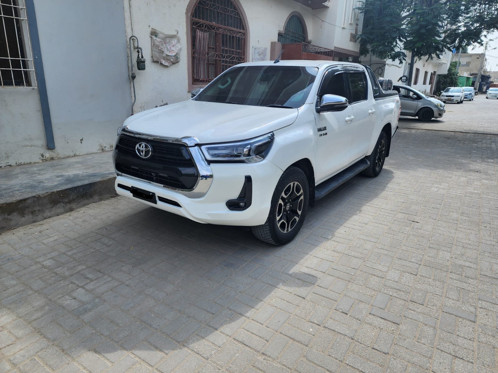 Revo with chauffeur parked near office building
