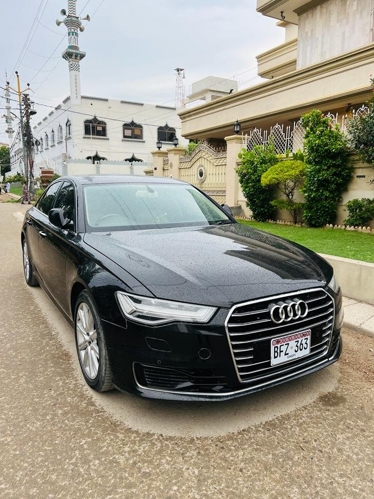 Side profile of black Audi A6 available for hire